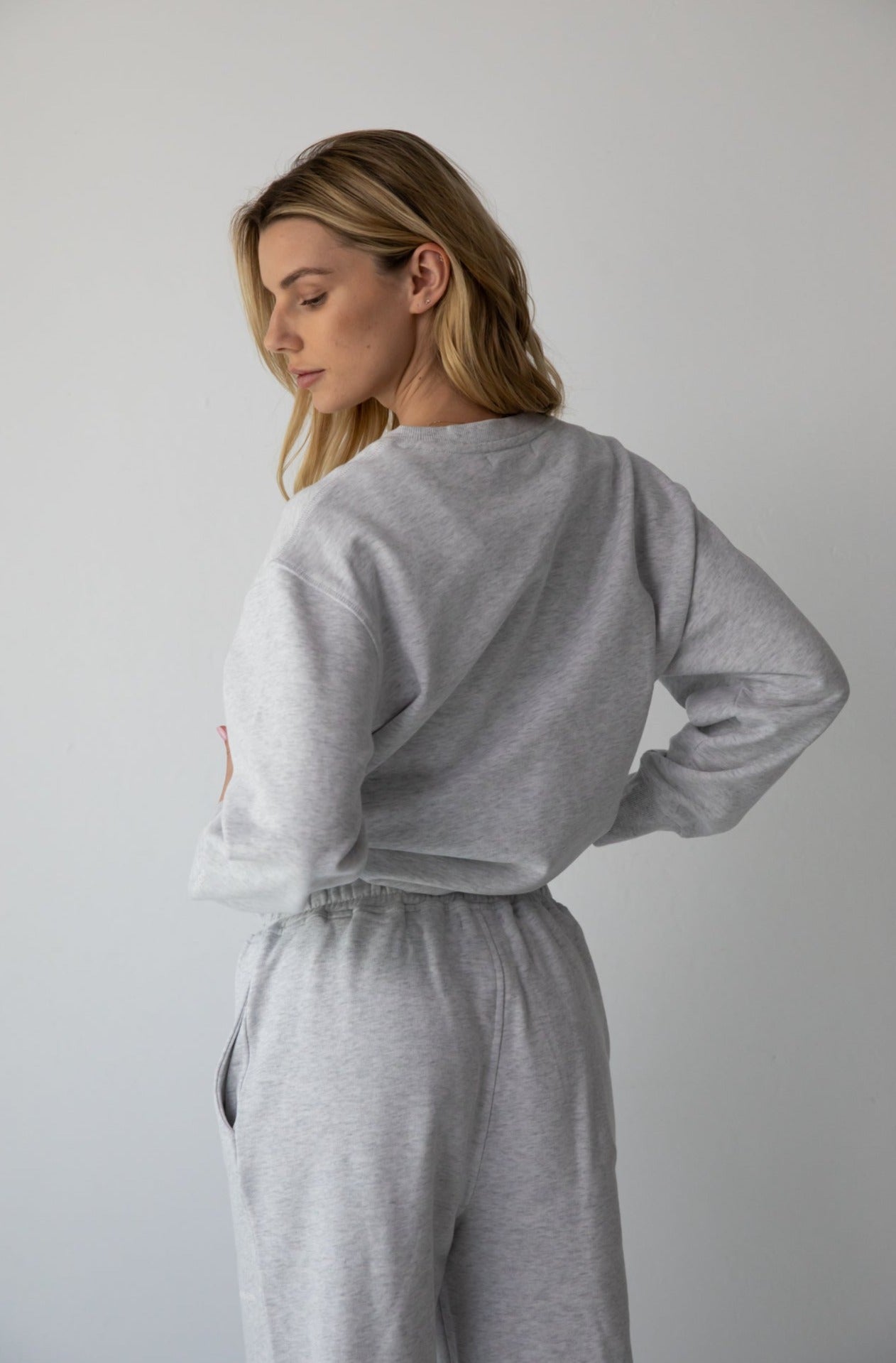 Woman wearing the NorthByOne Emma Baggy Sweat Pant in Marle Grey, with an elasticated waistband and a relaxed fit against a plain background