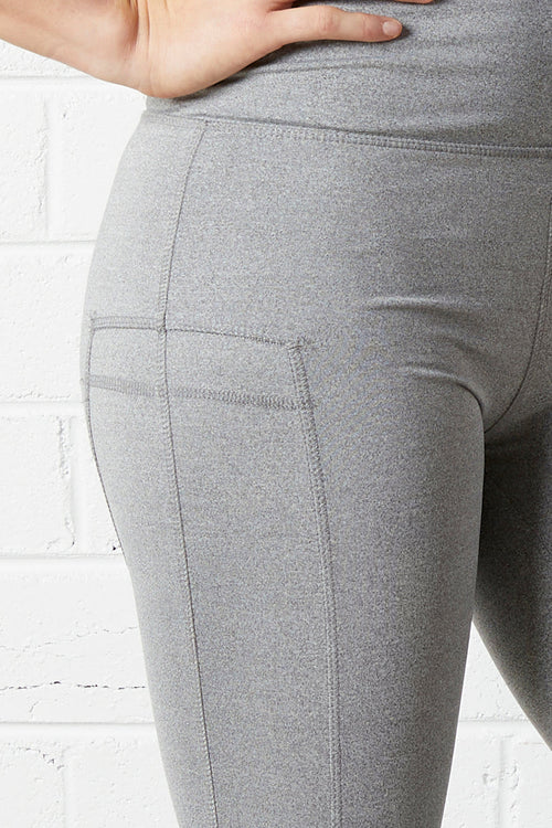Close-up of person wearing the NorthByOne Cara Three Quarter Tight - Marle Grey / Aqua showing fabric texture and side pocket detail